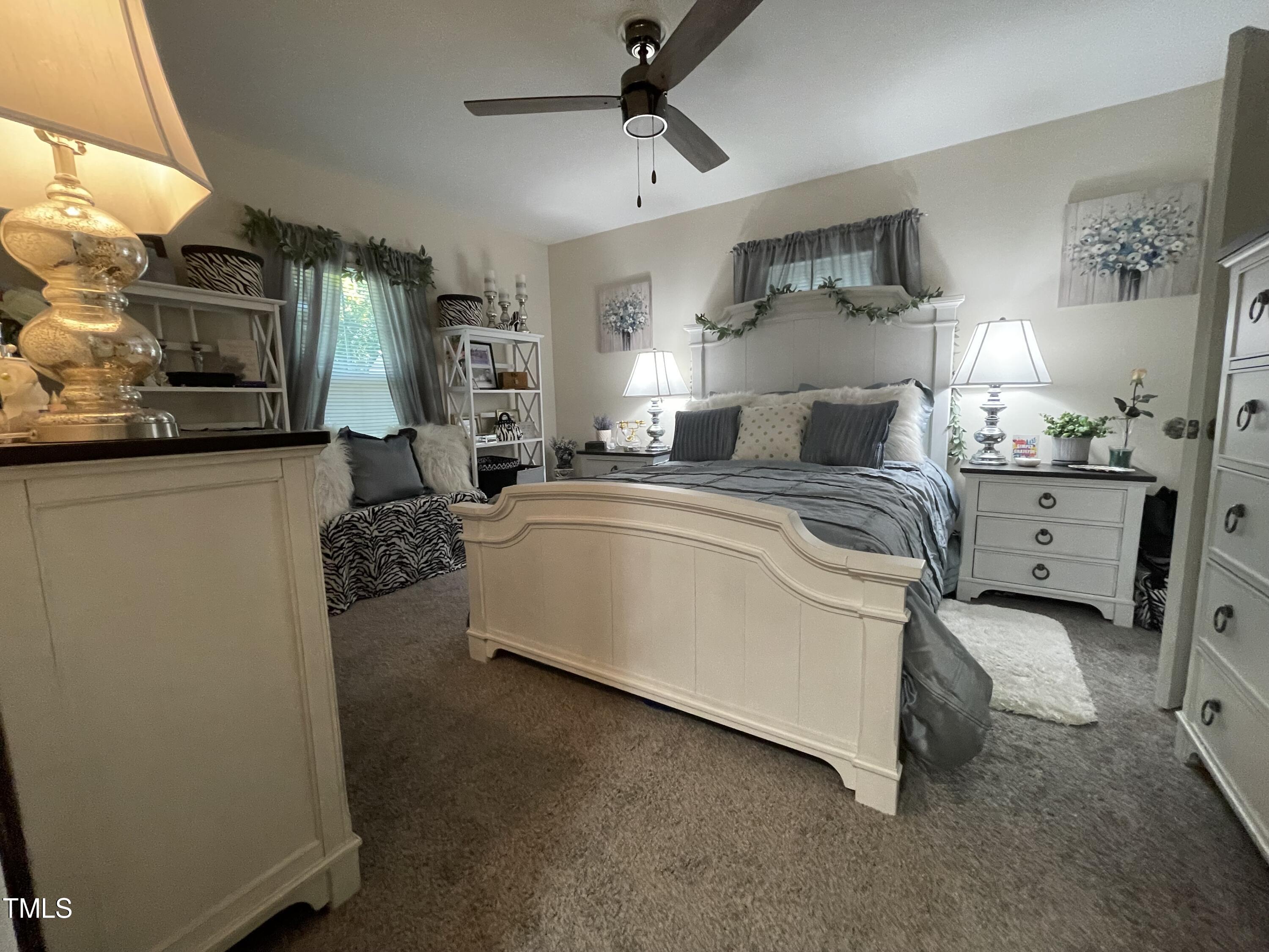 204 Jackson Street Dunn, NC 28334 - Photo 30 of 49 a bed room with furniture and a lamp