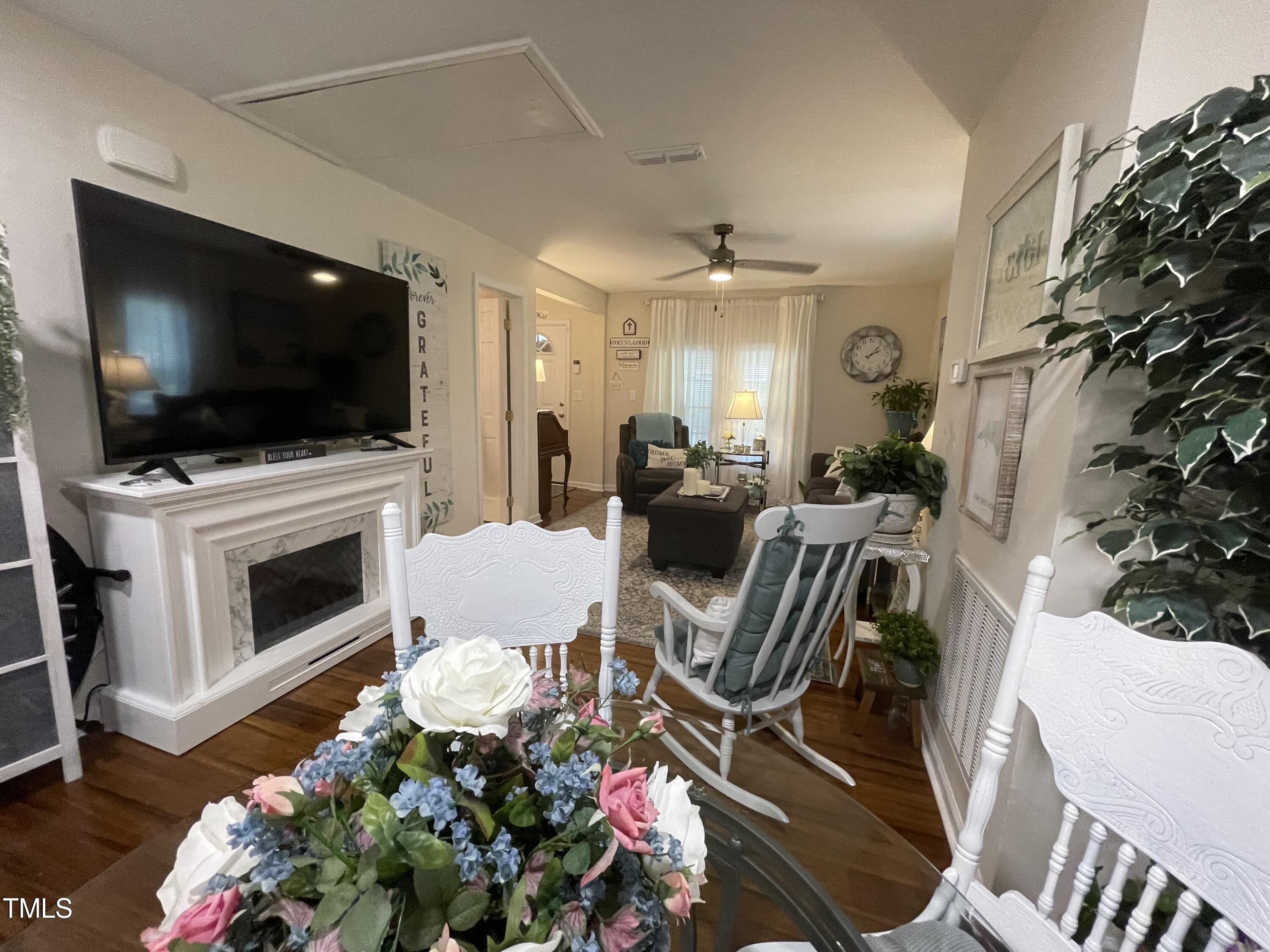 204 Jackson Street Dunn, NC 28334 - Photo 33 of 49 a living room with furniture a flat screen tv and a fireplace