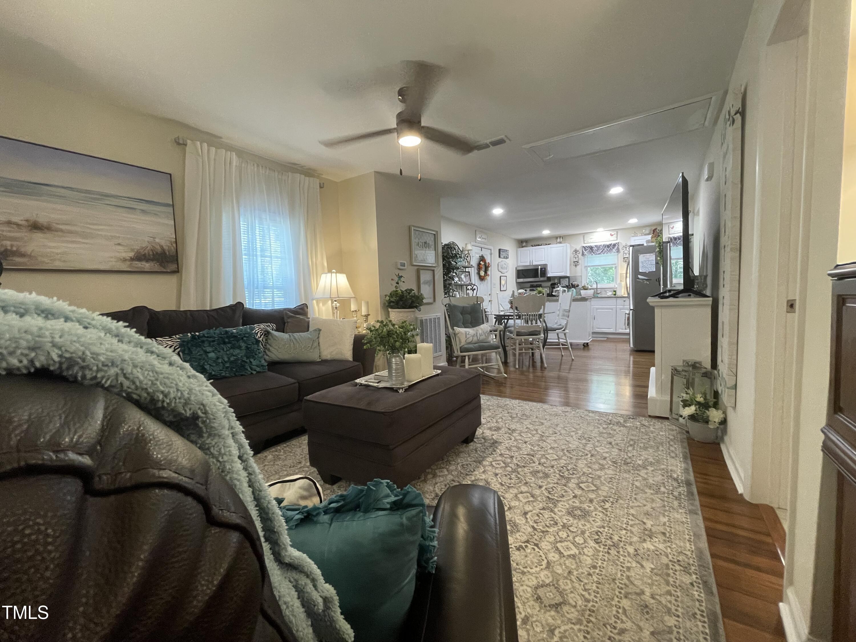 204 Jackson Street Dunn, NC 28334 - Photo 40 of 49 a living room with furniture and a dining table with kitchen view