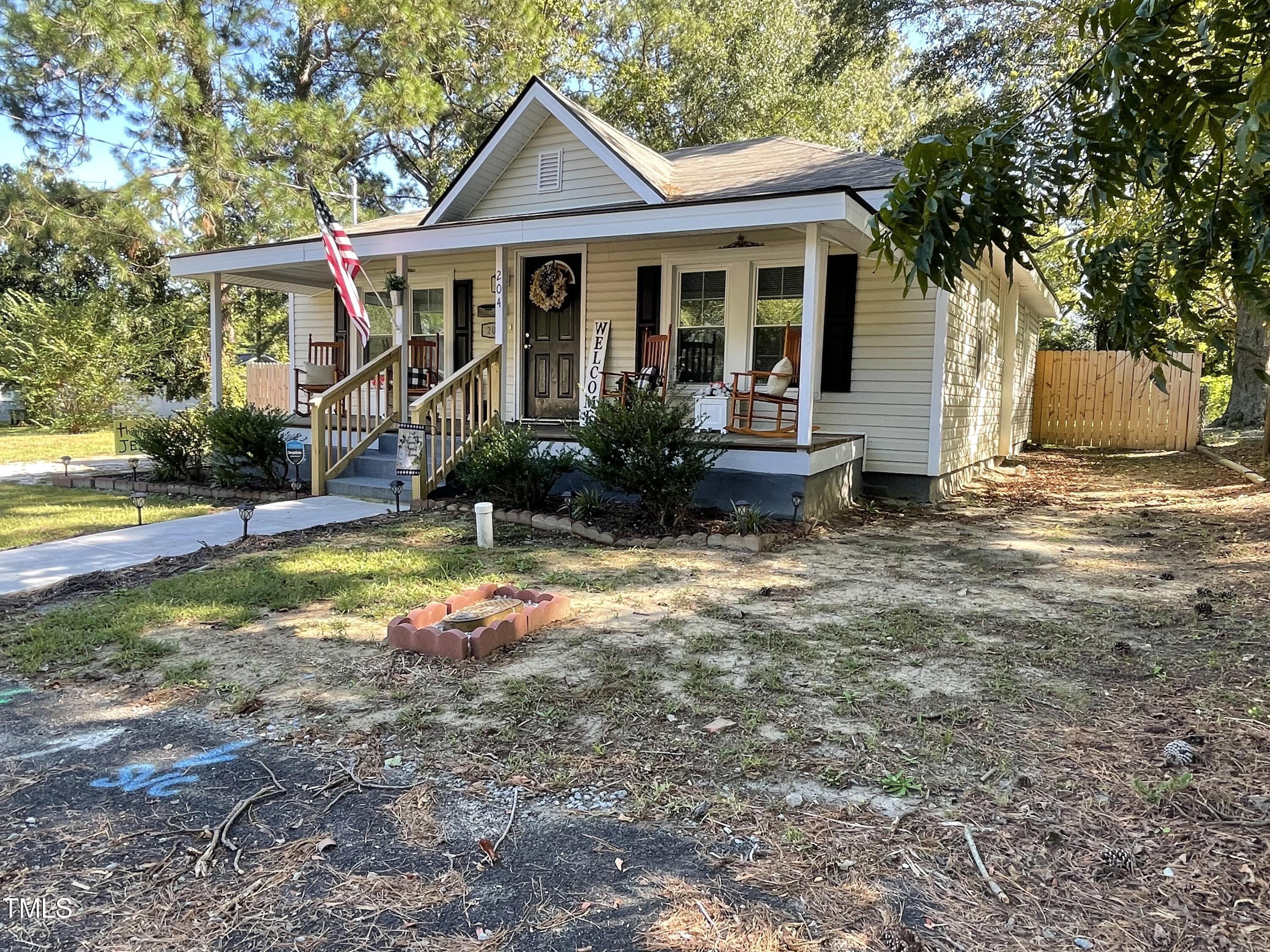 204 Jackson Street Dunn, NC 28334 - Photo 4 of 49 a view of a house with backyard and sitting area
