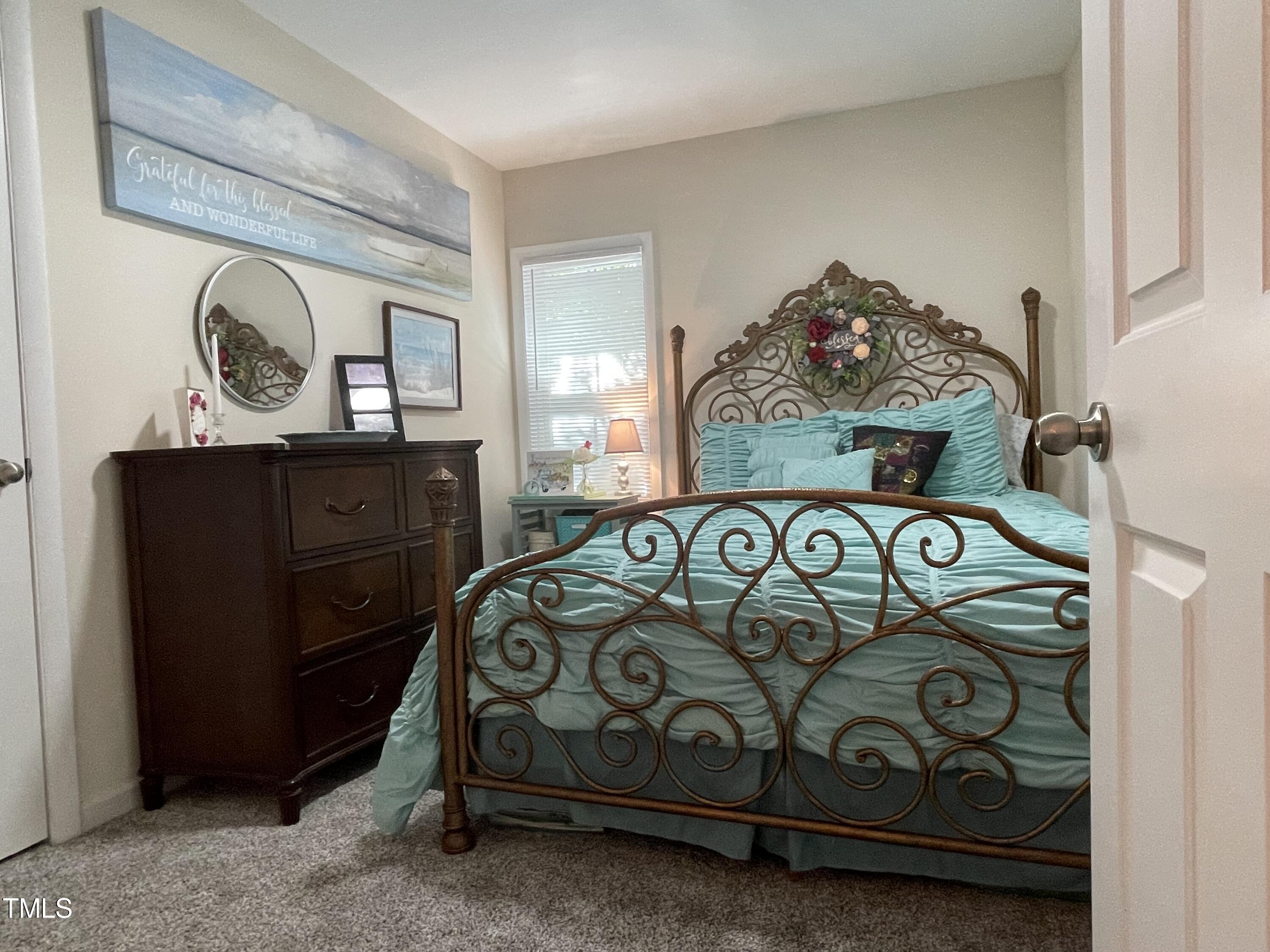 204 Jackson Street Dunn, NC 28334 - Photo 47 of 49 a bedroom with a bed and a dresser