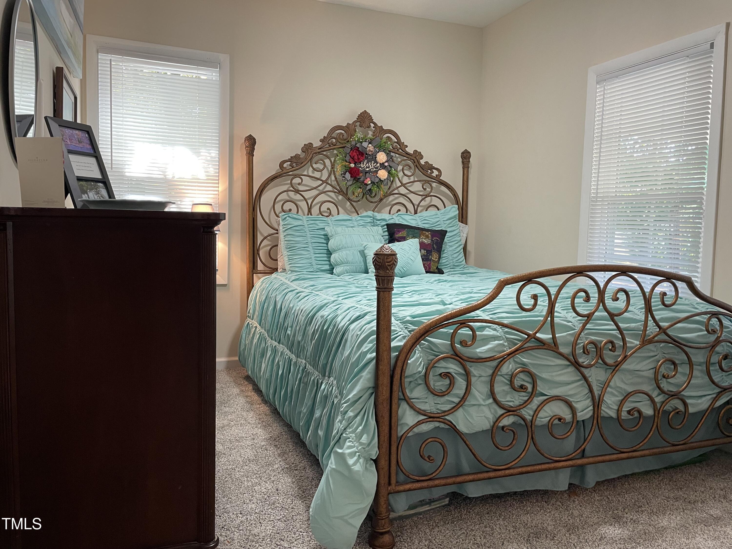 204 Jackson Street Dunn, NC 28334 - Photo 49 of 49 a bedroom with a bed and a table in it