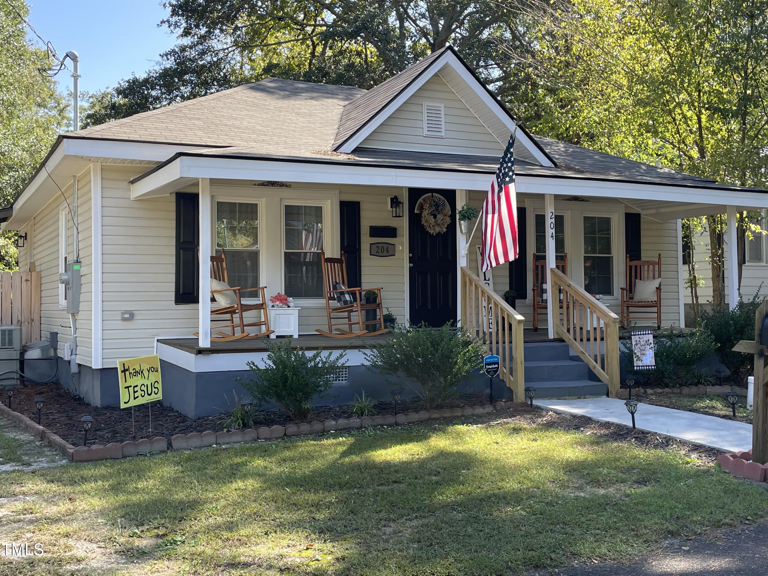204 Jackson Street Dunn, NC 28334 - Photo 5 of 49 a view of a house with swimming pool and porch