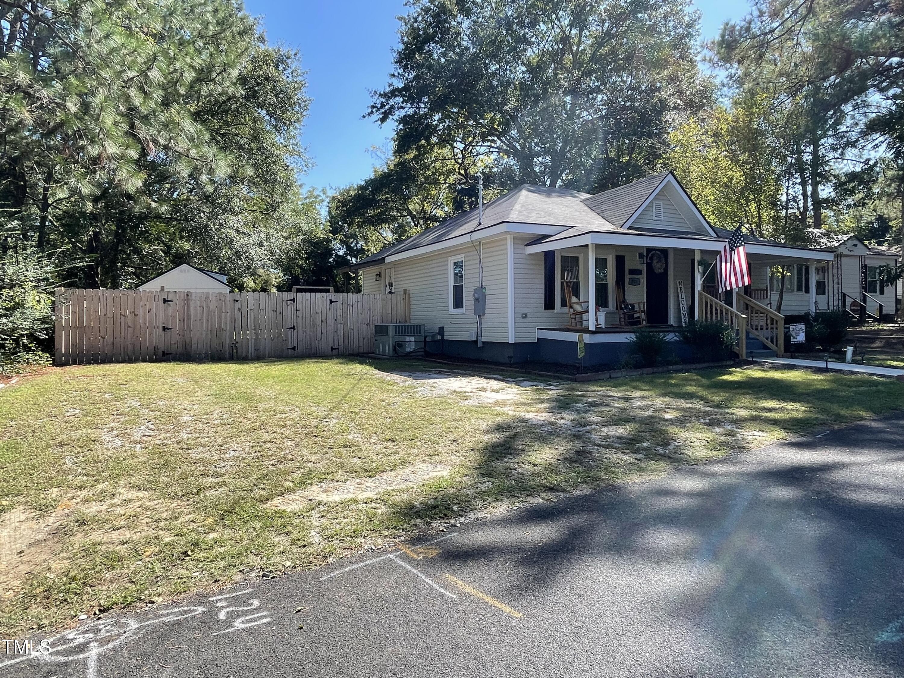 204 Jackson Street Dunn, NC 28334 - Photo 7 of 49 a front view of a house with a yard and large trees