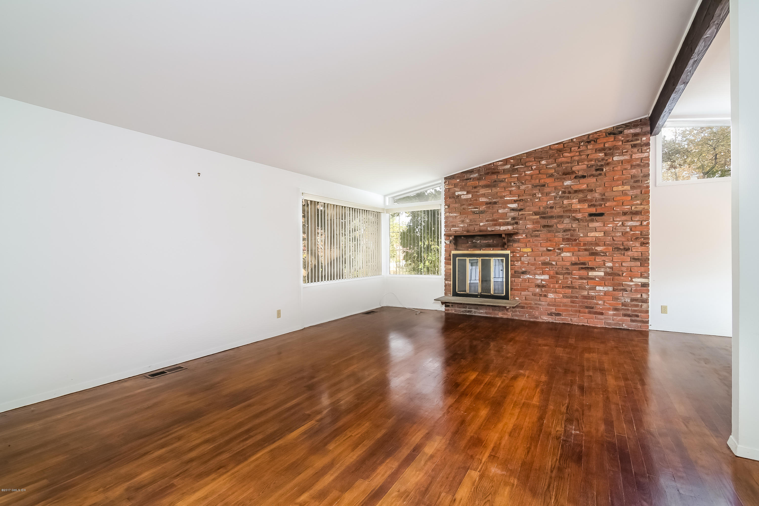 46 Crawford Terrace Riverside, CT 06878 - Photo 3 of 17 a view of an empty room with wooden floor and a window