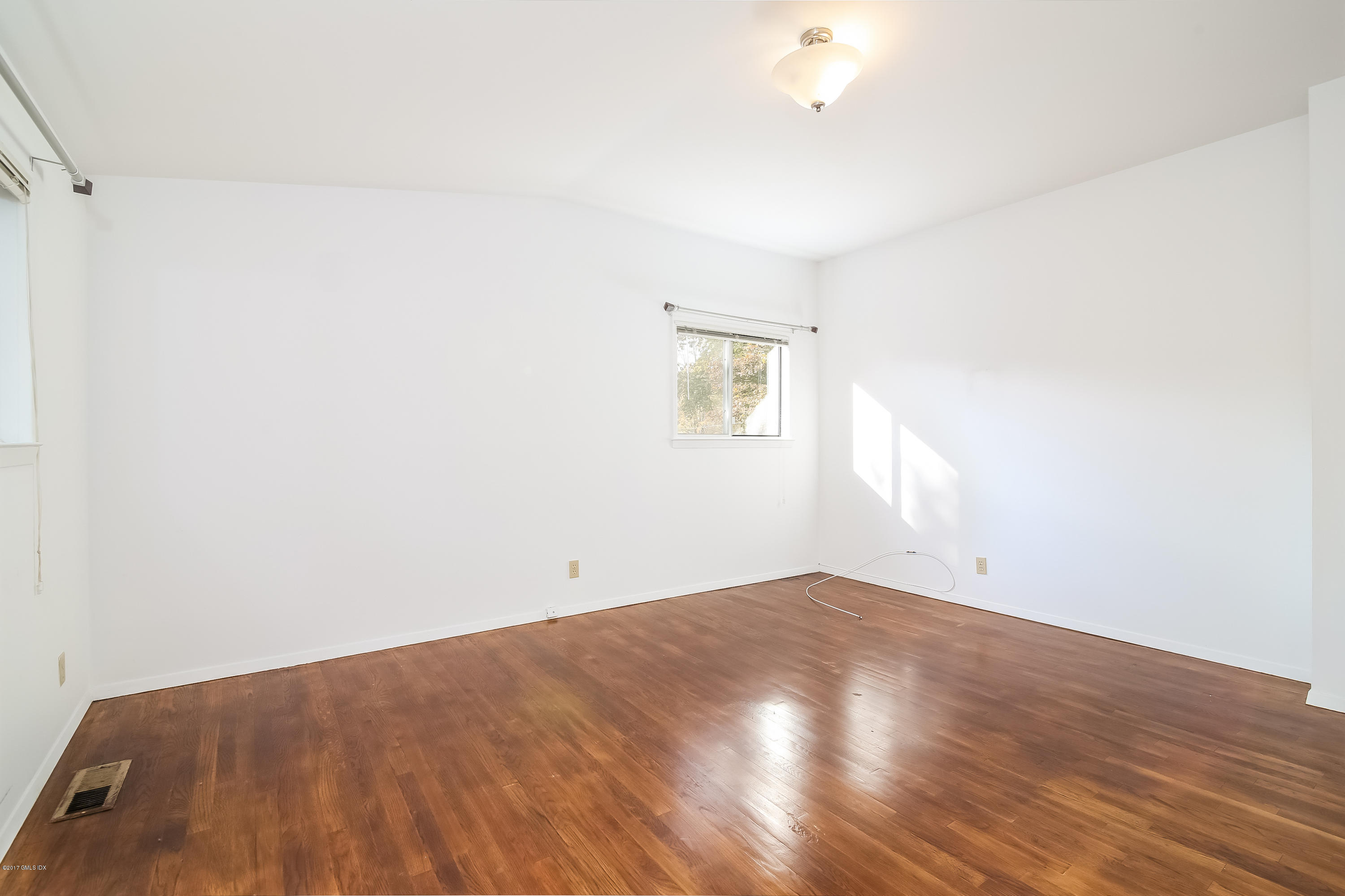 46 Crawford Terrace Riverside, CT 06878 - Photo 9 of 17 an empty room with wooden floor and windows