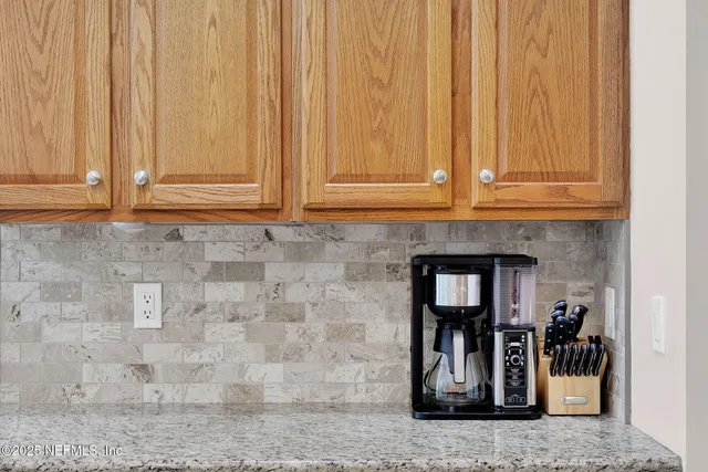 a spacious bedroom with a bed and a chandelier