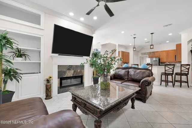 a bedroom with a large bed and a flat tv screen on dresser