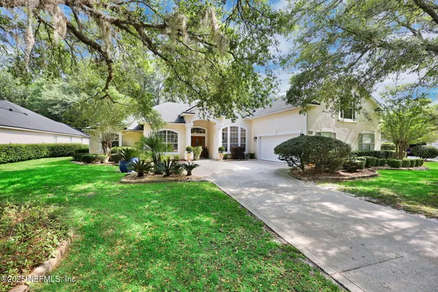 a view of a house with backyard garden and sitting area