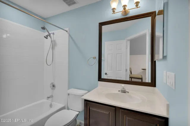 a bathroom with a shower curtain and a plant