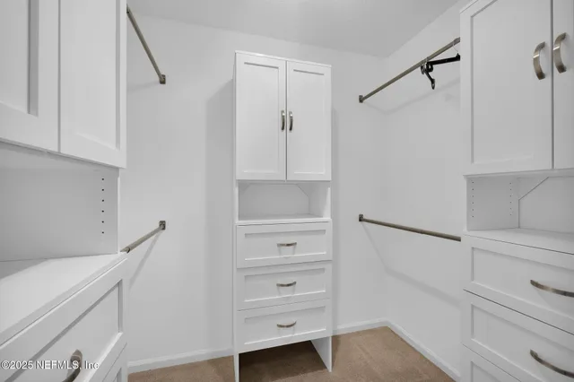 an aerial view of residential house with outdoor space and trees all around