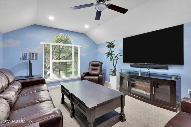 a front view of a house with a garden and trees