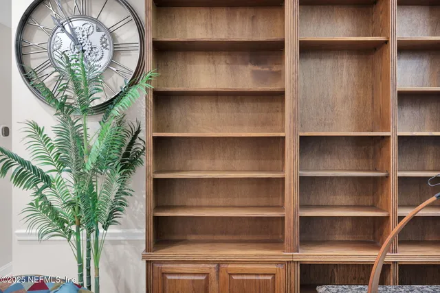 a living room with furniture a flat screen tv and a dining table