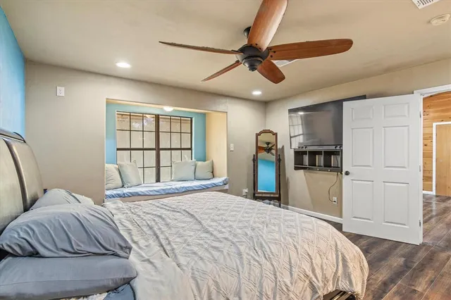 a bedroom with a bed and a window