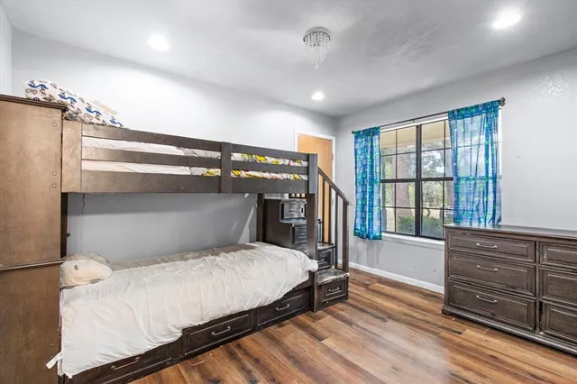 a bedroom with a large bed and a window