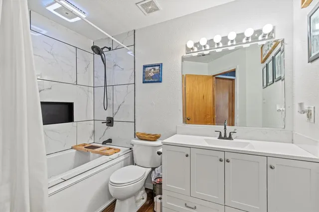 a bathroom with a sink a toilet and a mirror