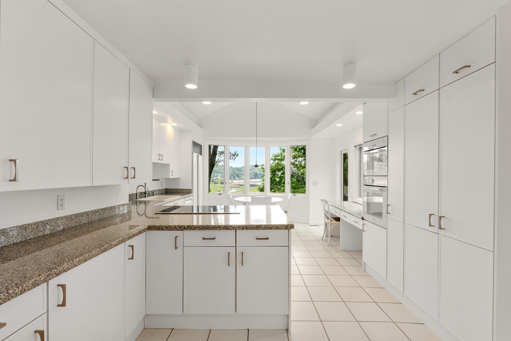 23 Ocean Street Manchester, MA 01944 - Photo 12 of 36 a large white kitchen with a large window