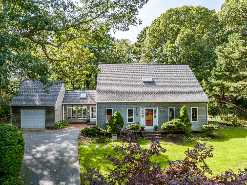 a front view of a house with a yard and outdoor seating