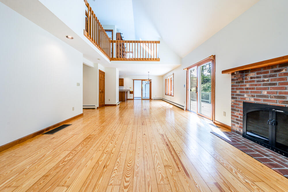 34 Ridgewood Road Orleans, MA 02653 - Photo 16 of 41 a view of a livingroom with wooden floor and staircase