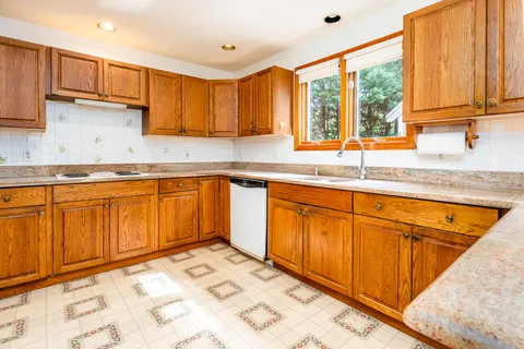 a kitchen with stainless steel appliances granite countertop sink stove and cabinets