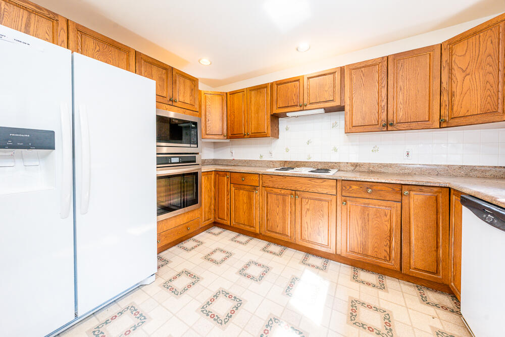 34 Ridgewood Road Orleans, MA 02653 - Photo 19 of 41 a kitchen with granite countertop a sink stainless steel appliances and cabinets