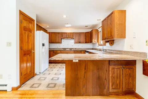 a kitchen with stainless steel appliances granite countertop a sink and cabinets