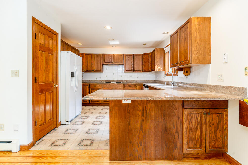 34 Ridgewood Road Orleans, MA 02653 - Photo 20 of 41 a kitchen with stainless steel appliances granite countertop a sink and cabinets