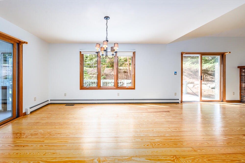 34 Ridgewood Road Orleans, MA 02653 - Photo 22 of 41 a view of an empty room with window and wooden floor