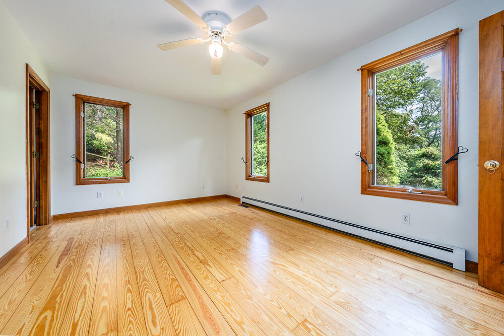 34 Ridgewood Road Orleans, MA 02653 - Photo 24 of 41 a view of an empty room with a window and wooden floor