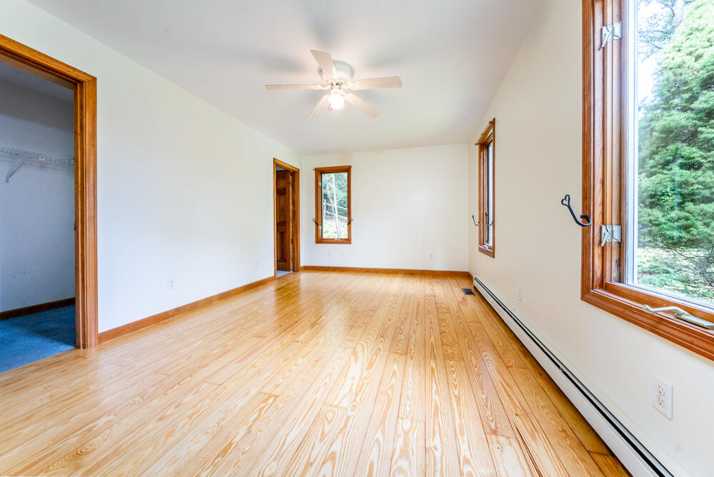 34 Ridgewood Road Orleans, MA 02653 - Photo 25 of 41 a view of an empty room with wooden floor and a window