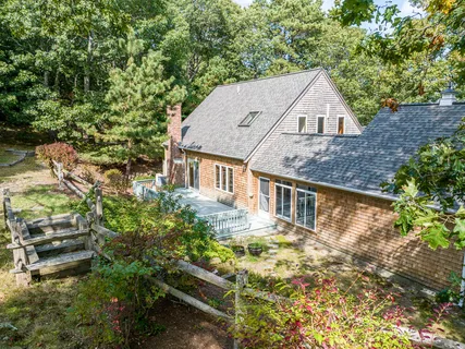 an aerial view of a house with a yard