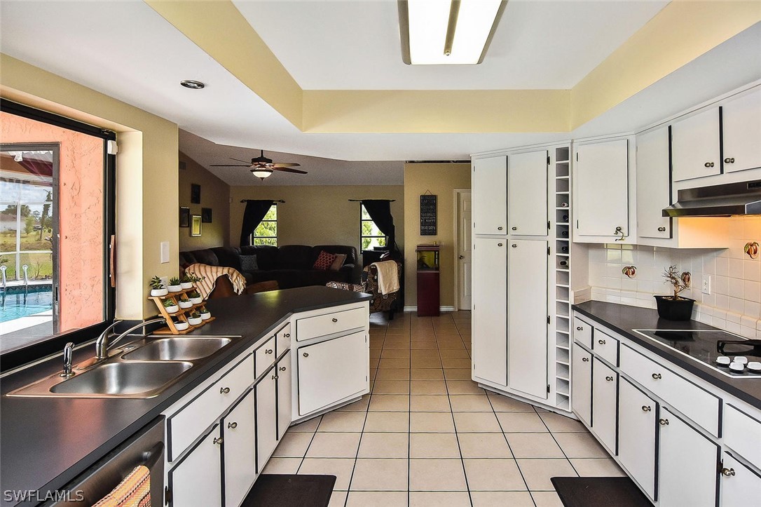 230 Danby Road Lehigh Acres, FL 33936 - Photo 3 of 35 a kitchen with stainless steel appliances granite countertop a sink stove and cabinets