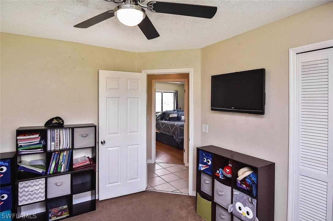 230 Danby Road Lehigh Acres, FL 33936 - Photo 34 of 35 a view of a livingroom with furniture and a flat screen tv