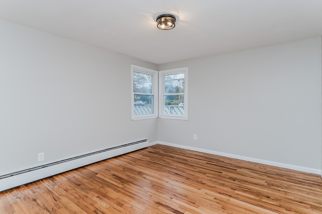 33 Grimard Street Ludlow, MA 01056 - Photo 14 of 27 wooden floor in an empty room with a window