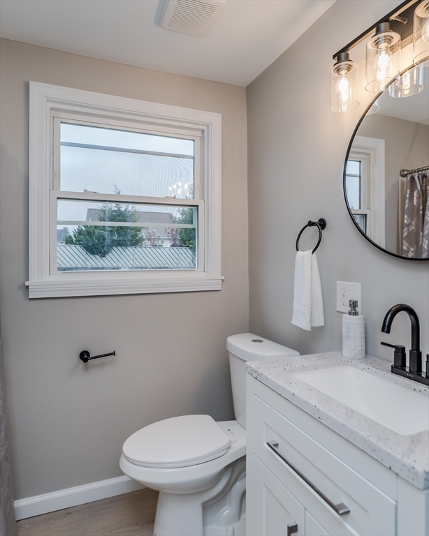 33 Grimard Street Ludlow, MA 01056 - Photo 9 of 27 a bathroom with a toilet a sink and mirror