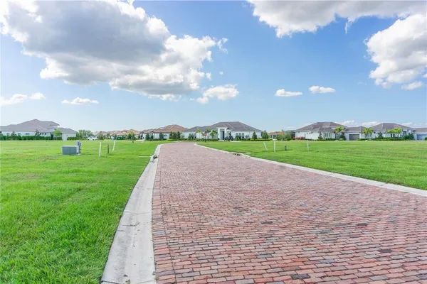 a view of a park with houses in the background
