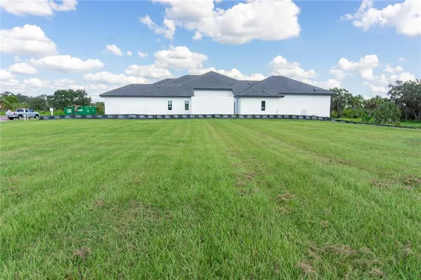 a view of a big house with a big yard