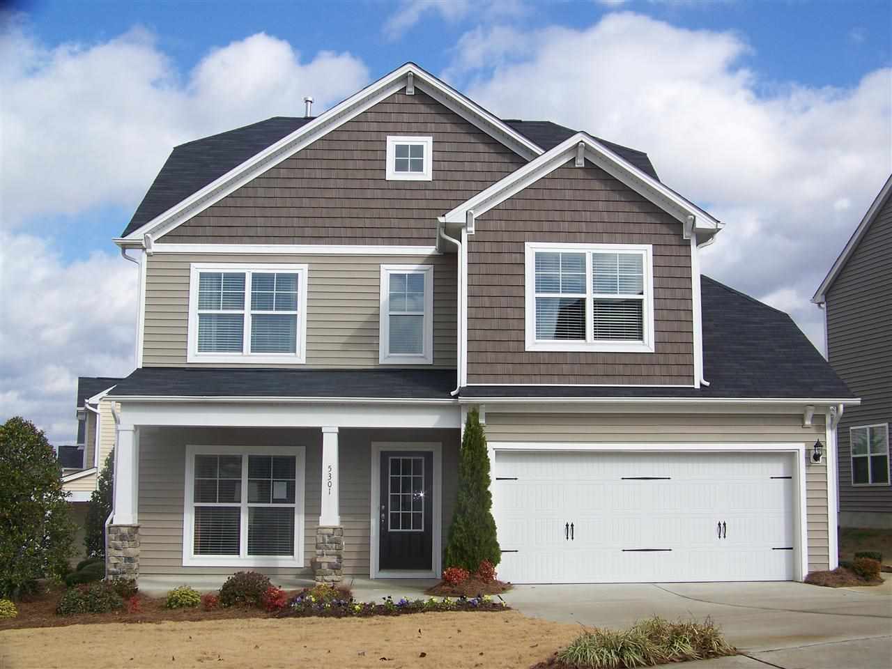 a front view of a house with garage and garage