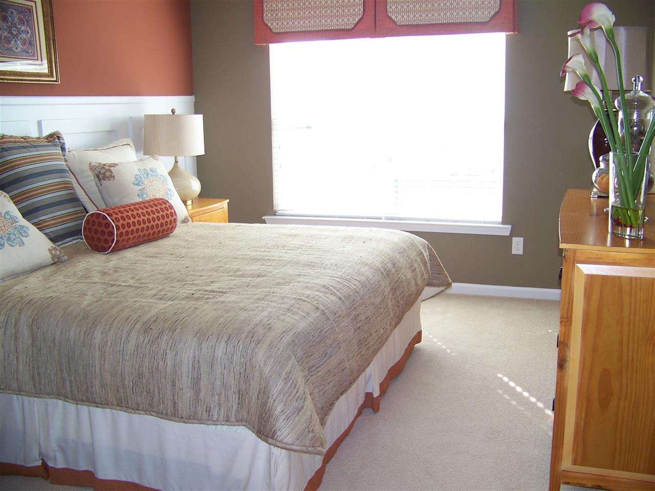 5301 Stowecroft Lane Raleigh, NC 27616 - Photo 11 of 25 a bedroom with a bed and a potted plant