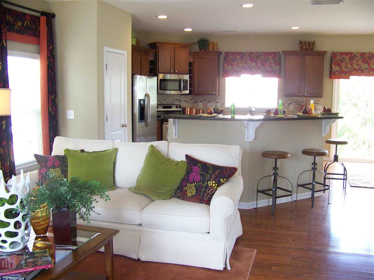 5301 Stowecroft Lane Raleigh, NC 27616 - Photo 3 of 25 a living room with stainless steel appliances kitchen island granite countertop furniture and a wooden floor