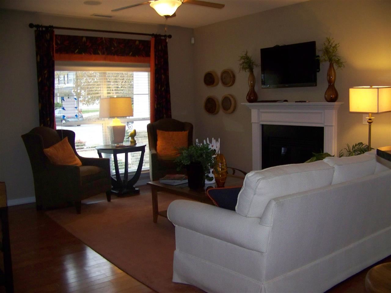 5301 Stowecroft Lane Raleigh, NC 27616 - Photo 4 of 25 a living room with furniture a flat screen tv and a fireplace
