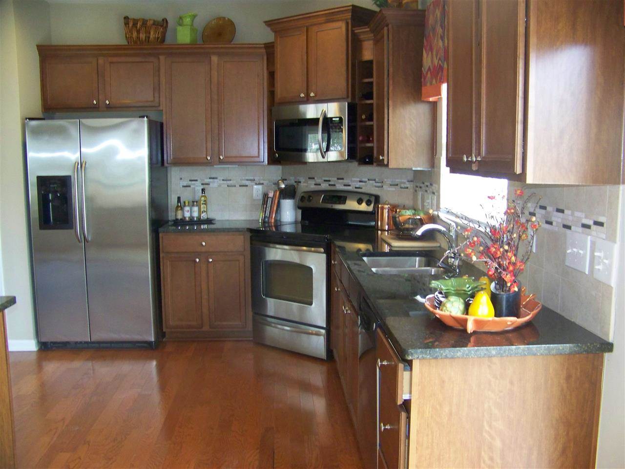 5301 Stowecroft Lane Raleigh, NC 27616 - Photo 5 of 25 a kitchen with stainless steel appliances granite countertop a sink stove and refrigerator