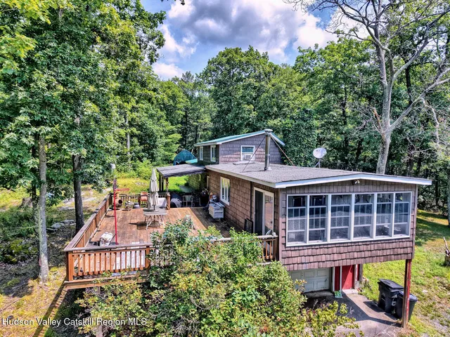 an aerial view of a house with a yard and large trees