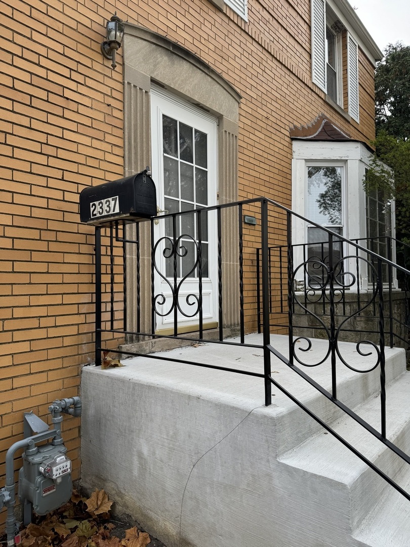 2337 South 3rd Avenue North Riverside, IL 60546 - Photo 3 of 17 a view of a brick building with a bench in front of it
