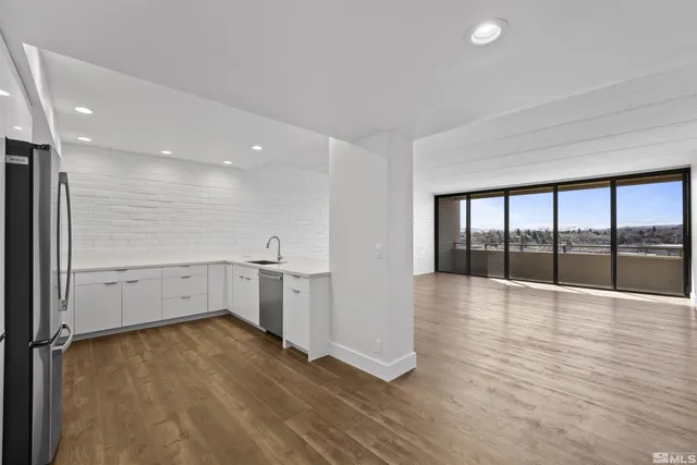 a living room with furniture and floor to ceiling windows