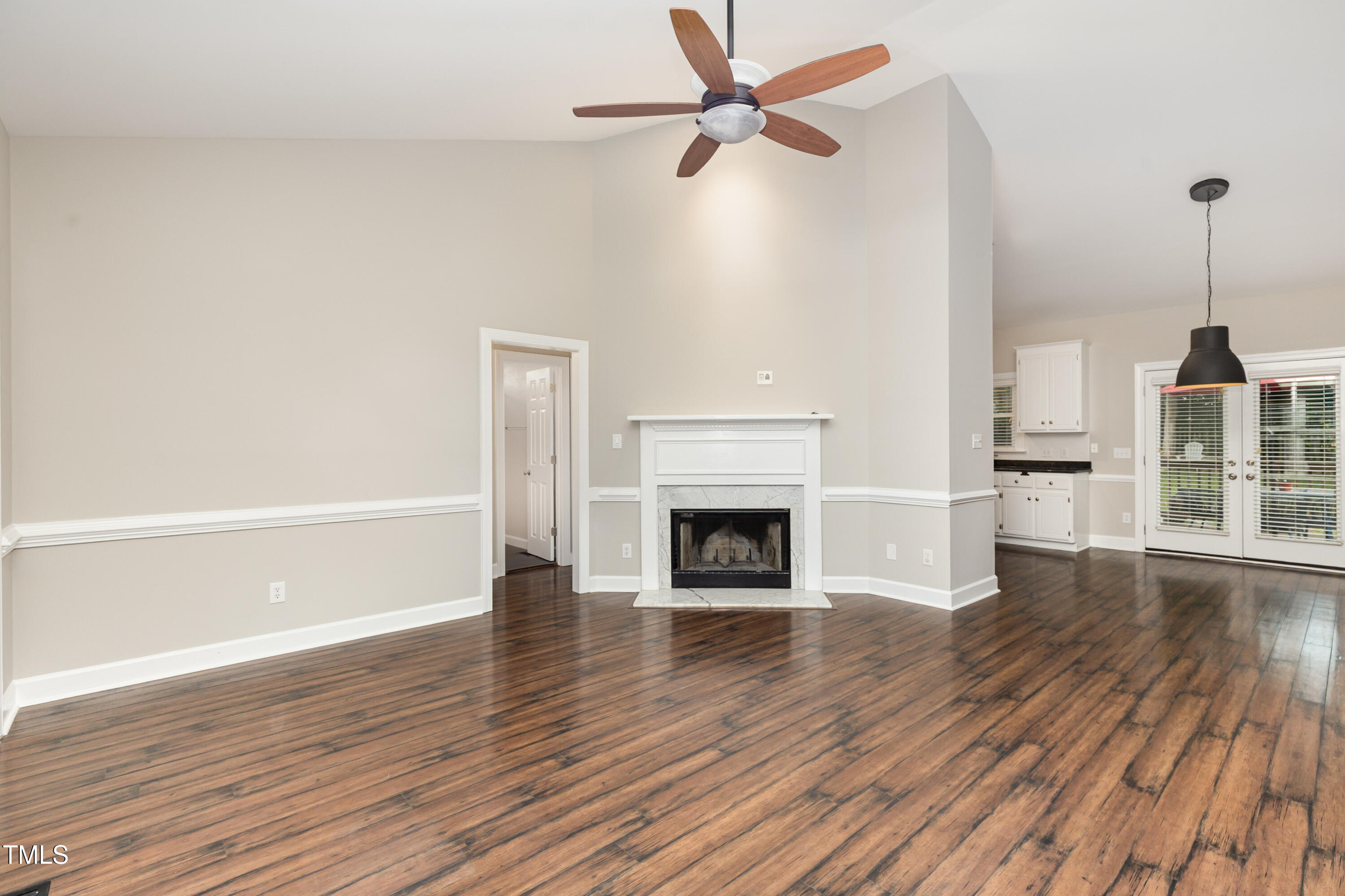 9316 Dawnshire Road Raleigh, NC 27615 - Photo 12 of 31 a view of empty room with wooden floor and fan