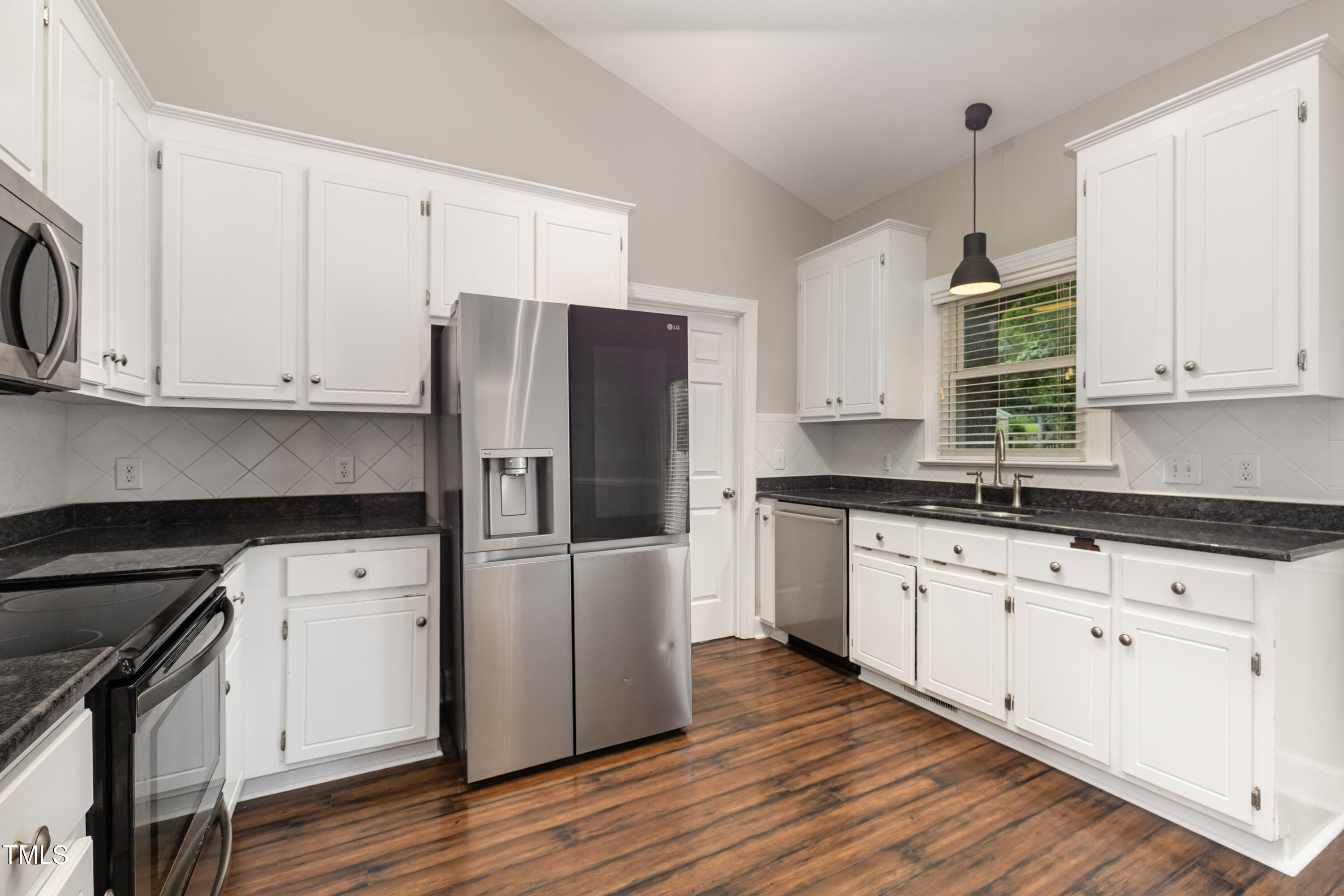 9316 Dawnshire Road Raleigh, NC 27615 - Photo 14 of 31 a kitchen with granite countertop wooden cabinets and a stove