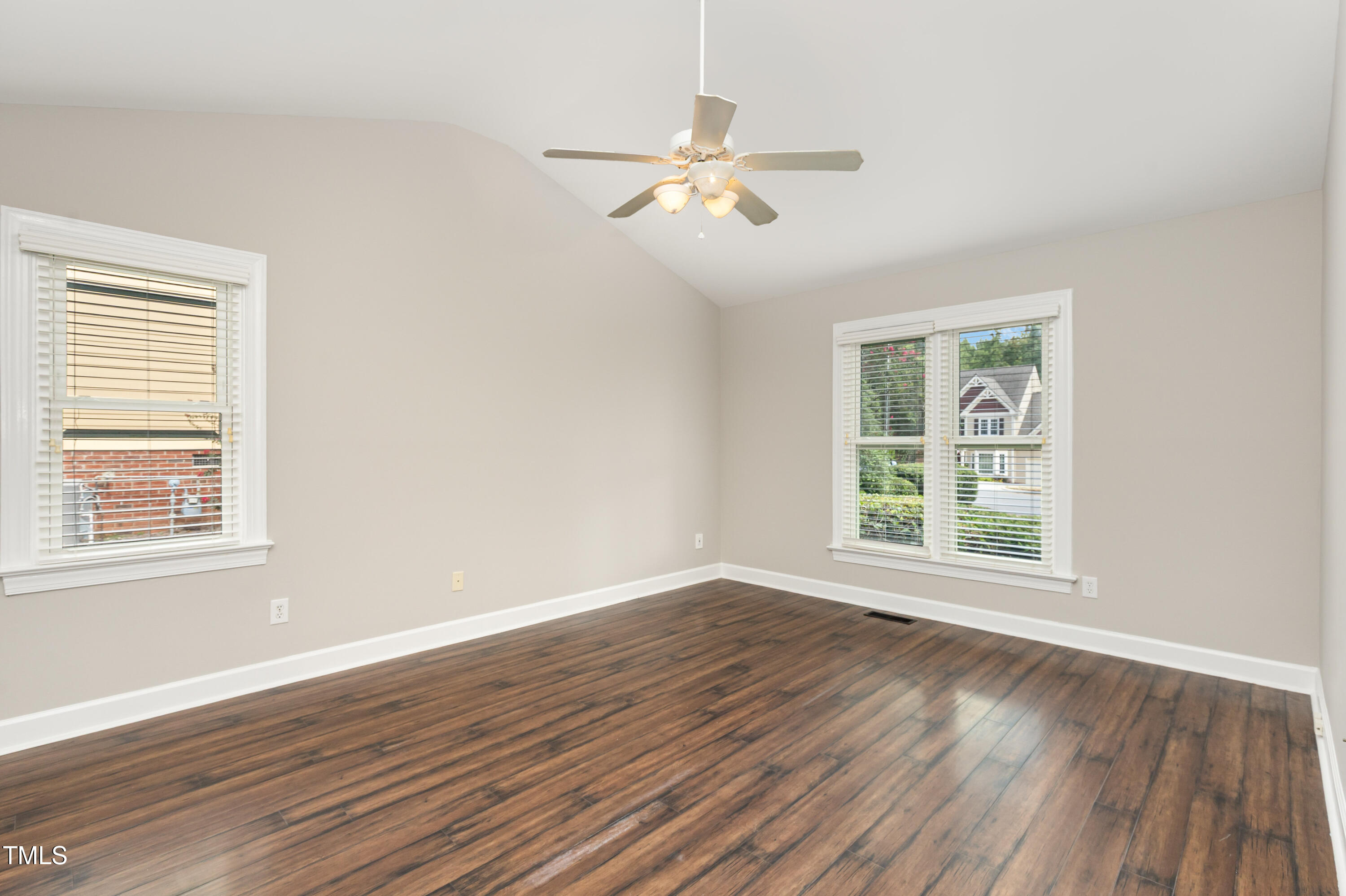 9316 Dawnshire Road Raleigh, NC 27615 - Photo 17 of 31 a view of an empty room with wooden floor and a window