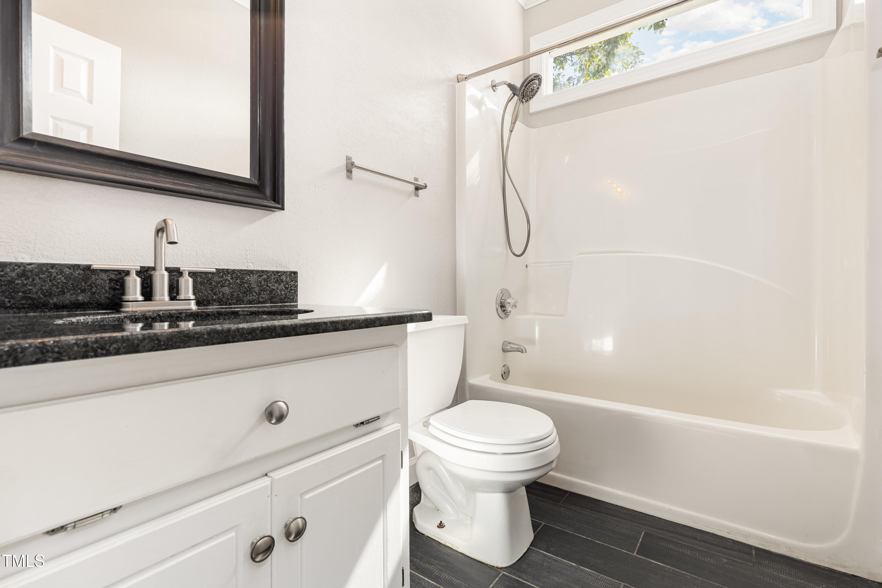 9316 Dawnshire Road Raleigh, NC 27615 - Photo 21 of 31 a bathroom with a sink a toilet and shower