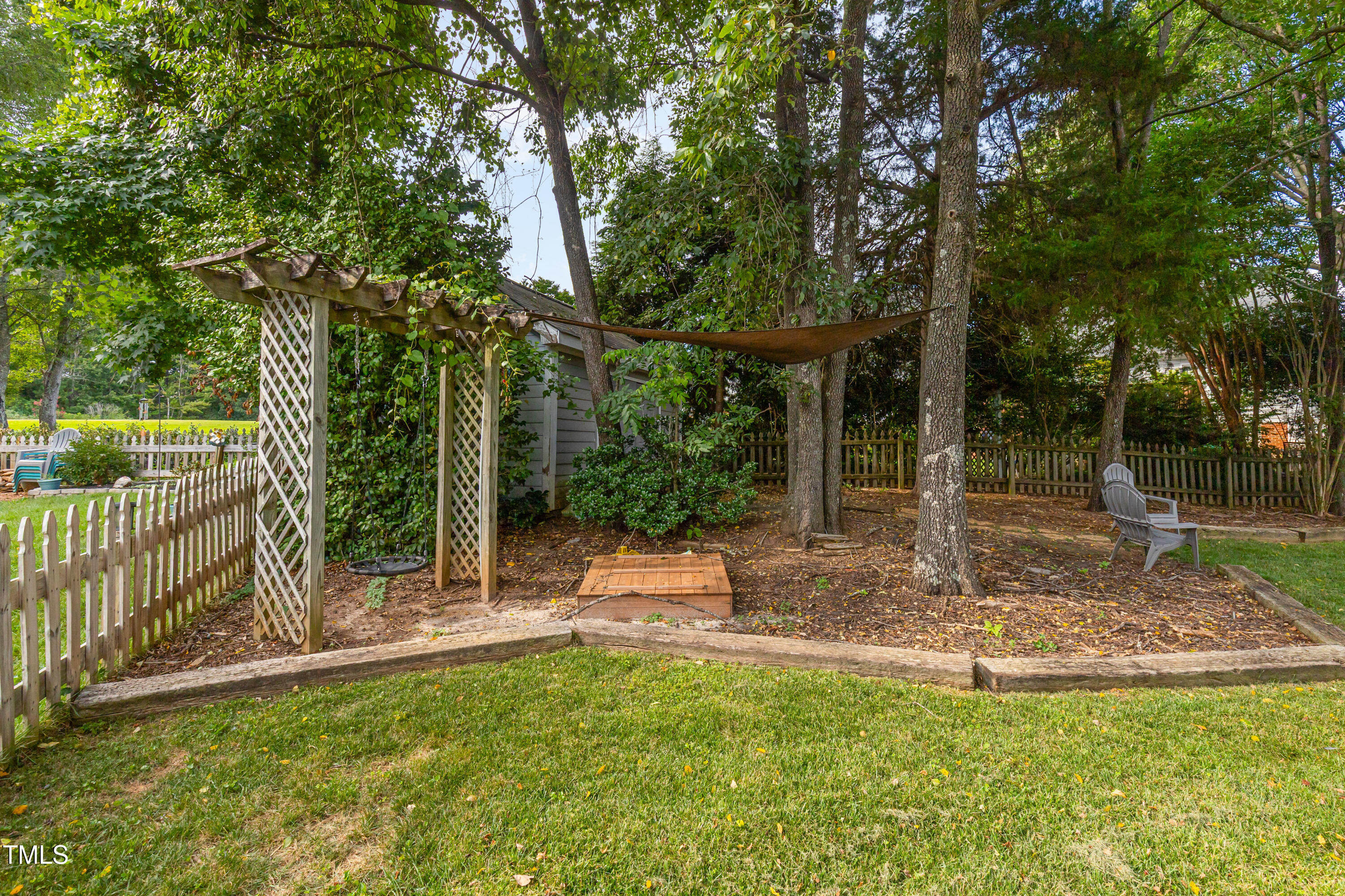 9316 Dawnshire Road Raleigh, NC 27615 - Photo 23 of 31 a view of a garden with a tree